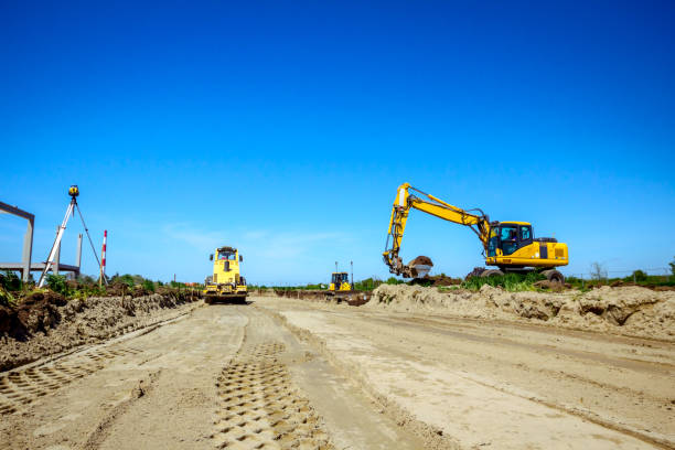 istock Excavator and huge road roller are working at construction site 1171266012