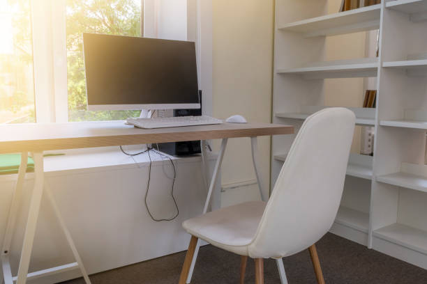 istock Education background with desk, computer, white chair and bookshelves 1171274342