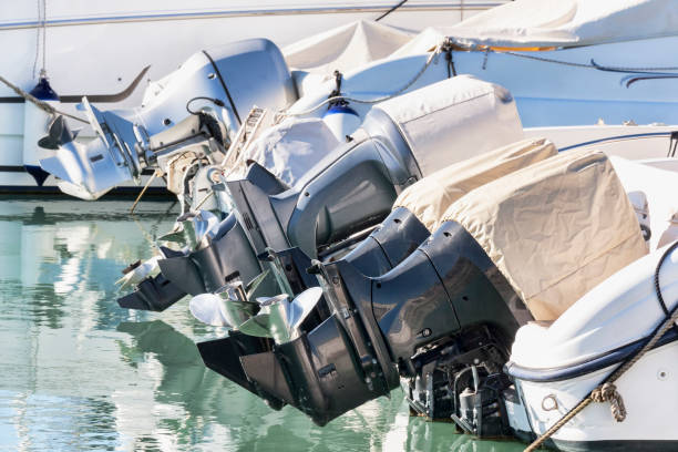 a row of outboard nautical engines mounted on fiberglass boats - outboard motor imagens e fotografias de stock