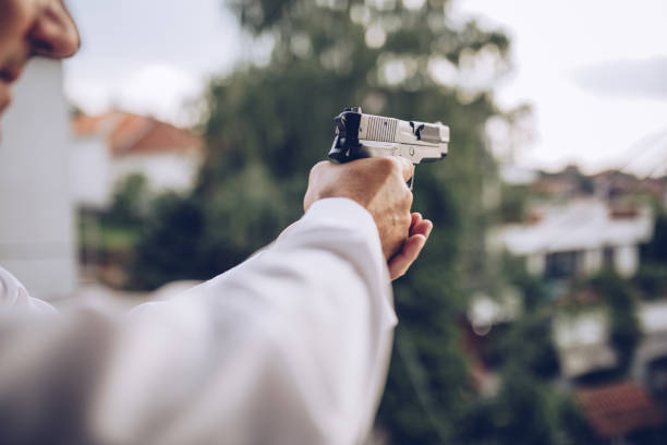 istock Detective in action with a gun 1171278017