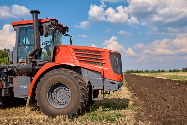 istock Tractor plows field, cultivators soil for sowing 1171279193