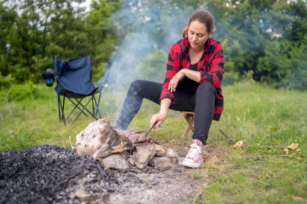 istock Young girl preparing food on grill 1171280141