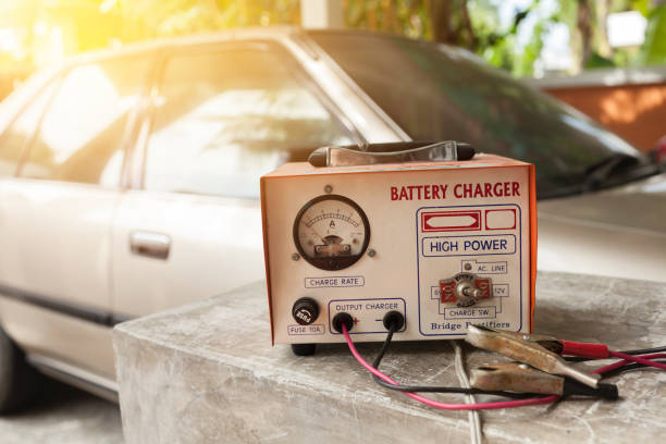 istock Car battery charger over blurred car background 1171280977