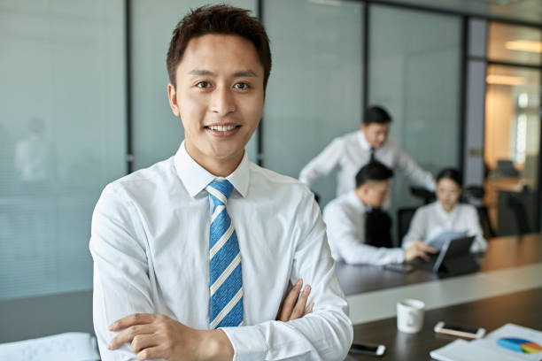 istock Smiling businessman standing with arms crossed 1171288126