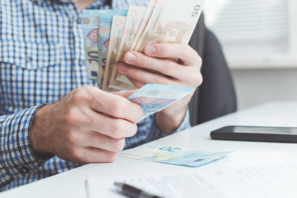 istock Businessman counts a money in office 1171297299