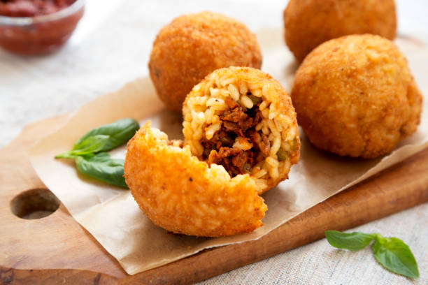 istock Homemade fried Arancini with basil and Marinara on a white wooden background, side view. Italian rice balls. Closeup. 1171299961