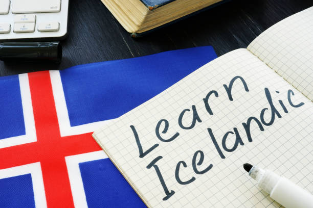istock Learn Icelandic written on a page and flag. 1171300101