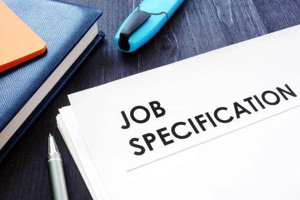 istock Job specification on the black desk and pen. 1171300118