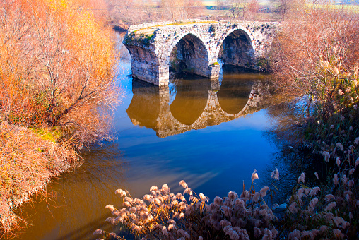 The ruins of an ancient Roman bridge over the river