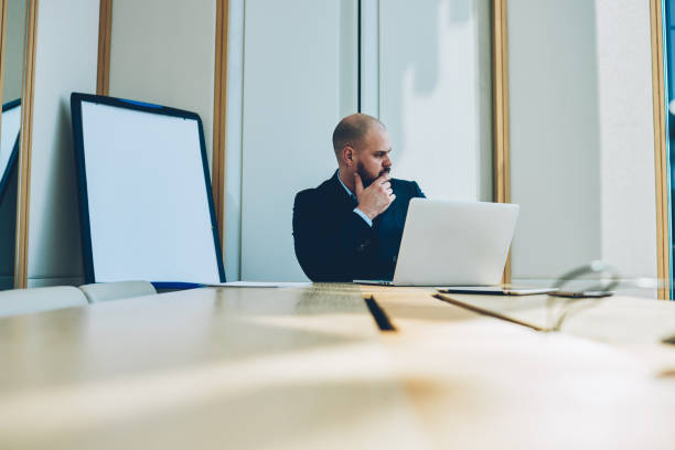 istock Thoughtful confident proud ceo thinking on productive strategy working at modern laptop device 1171301478