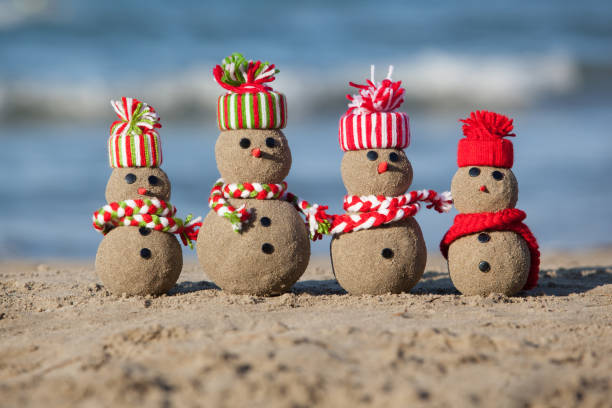 familia de hombres de arena snowmen en la playa tropical. - santa claus waving christmas photography fotografías e imágenes de stock