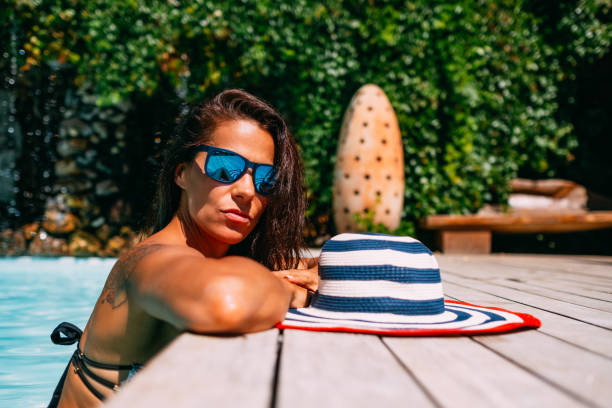 istock Attractive Tanned Woman by the Pool 1171306725