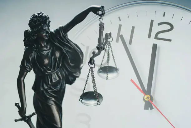 Photo of Justice holding the scales of justice and law