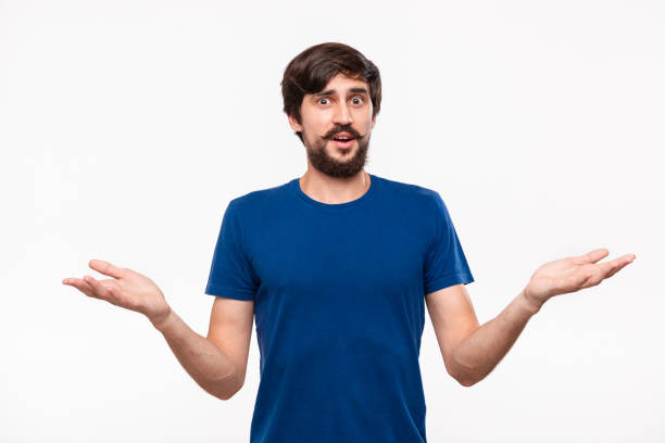 handsome brunet man in a blue shirt with beard and mostaches shrugging his shoulders being clueless standing isolated over white background. - blank expression head and shoulders horizontal studio shot imagens e fotografias de stock