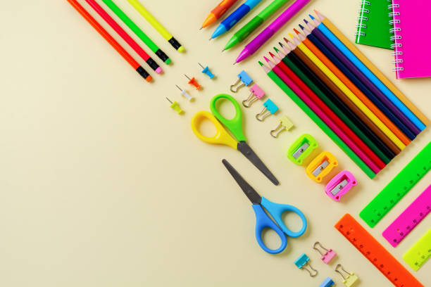 istock Notebook, colored pencils, ruler, pen, eraser, sharpener and more. School and office stationery on yellow background. Concept back to school. Top view. 1171308136