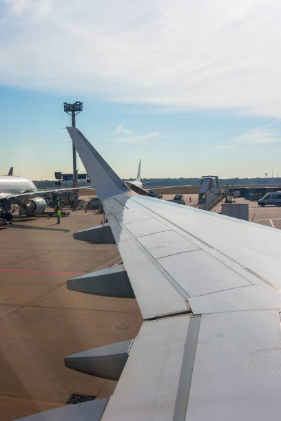 istock View at the wing from a airplane at the airfield 1171310808