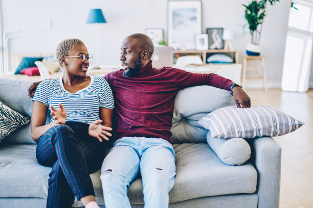 istock Young african american marriage having discussion about problem sitting at couch in living room, romantic couple talking about relationship looking at each other spending time together at living room 1171314361