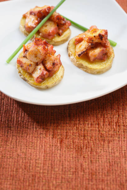 istock Potato starters with octopus, presentation of catering for celebration. Served on colored tablecloth. 1171316859
