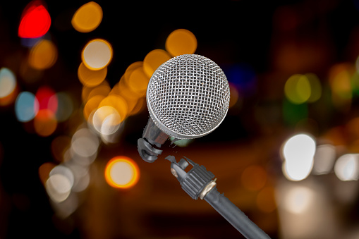 A microphone in-front of blurred colourful lights