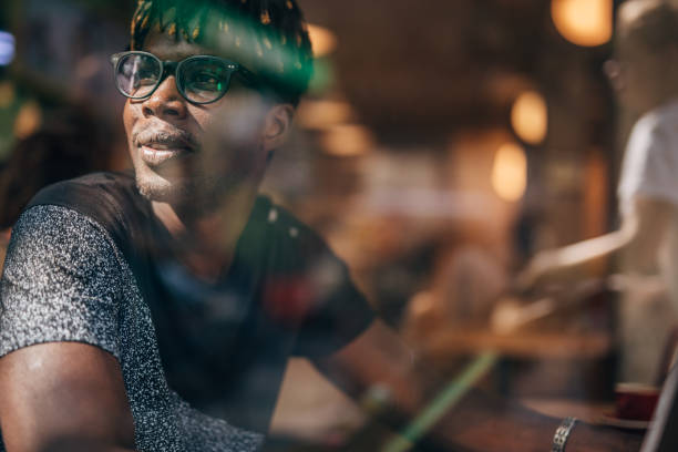 istock Young man sitting in coffee shop and using laptop 1171320487