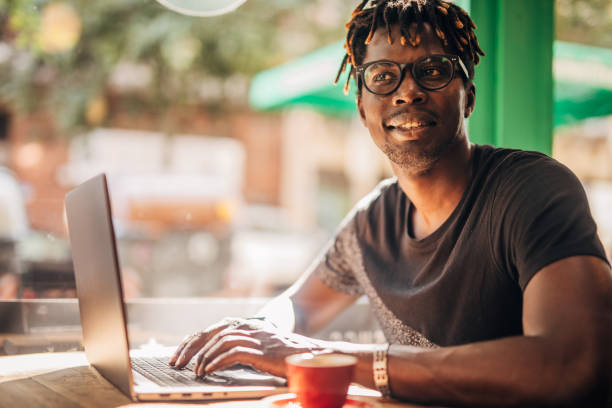 istock Young man sitting in coffee shop and using laptop 1171320589