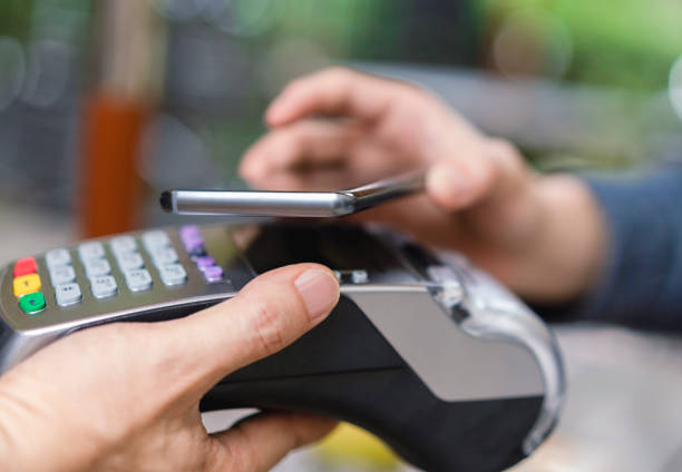 istock Close-up of hands holding technologies at checkout 1171321492