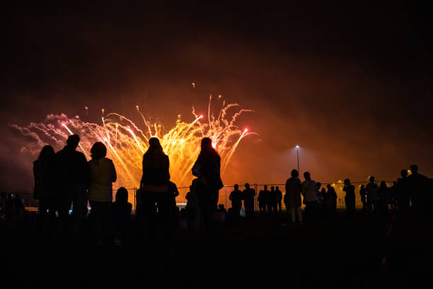 istock people look at the festive bright fireworks in the night sky 1171324151