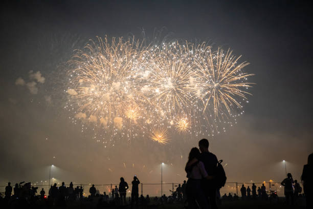 istock people look at the festive bright fireworks in the night sky 1171324228