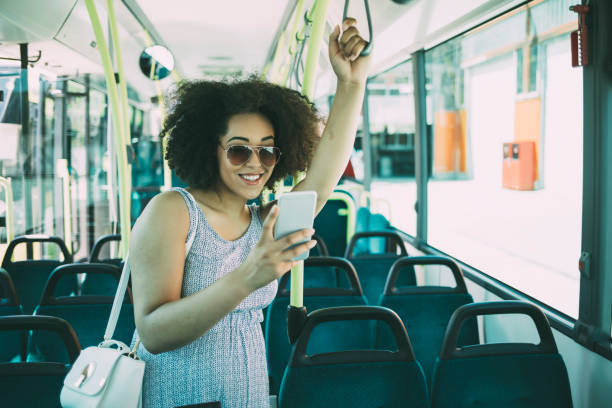 istock African woman using smart phone in bus 1171324713