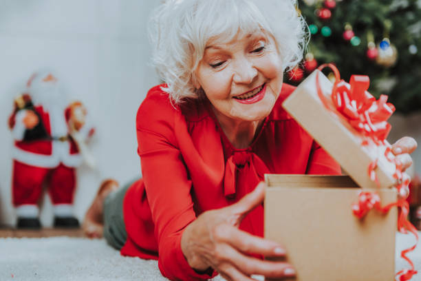 istock Happy gray-haired woman is looking in box 1171326087