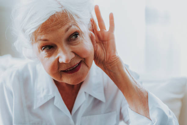 istock Elderly woman is holding hand by her ear 1171326147