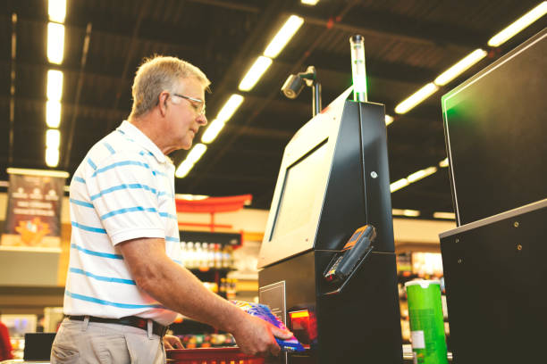 istock Man paying in a supermarket in a self service 1171326732