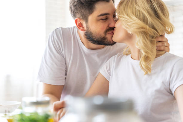 istock Handsome man kissing pretty lady on the lips 1171329710