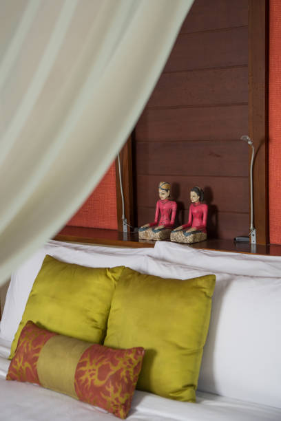 istock Bed with white linen, pillows and mosquito net. Vintage Interiors. Bed with canopy net. 1171330525