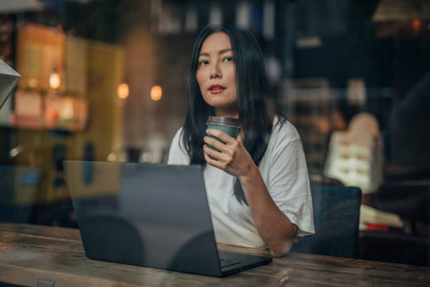 istock Young woman working on laptop in cafe 1171332306