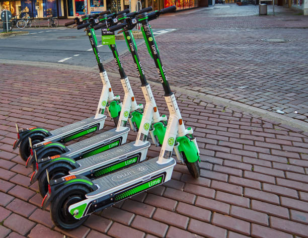 Parked e-shooters for rent on the sidewalk Hannover, Germany, August 24., 2019: Parked e-shooters for rent on the sidewalk lime scooter stock pictures, royalty-free photos & images