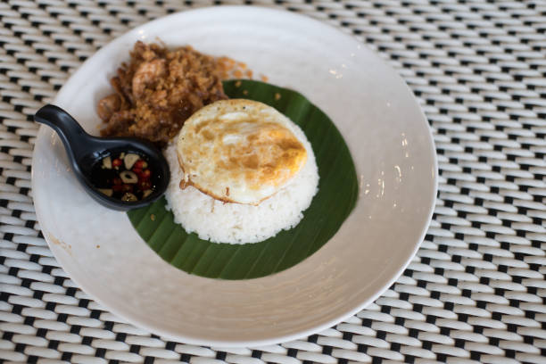 istock Steam rice with fried egg and stir-fried pork with garlic,Thai food. Selective focus 1171337738