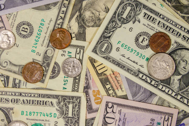 Background of different american dollars bills and coins stock photo