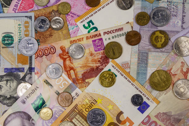 istock Background of banknotes and coins from different countries 1171338703