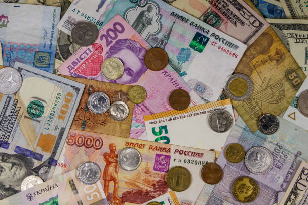 istock Background of banknotes and coins from different countries 1171338704