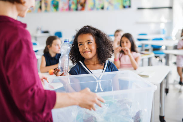 istock A teacher with small school kids in classroom learning about waste separation. 1171340297