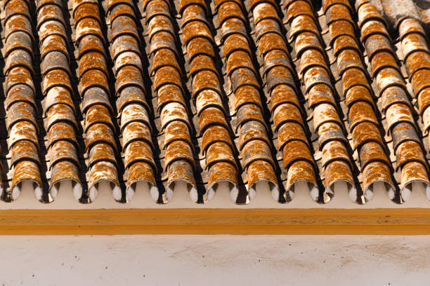 Traditional old Spanish ceramic roof tiles on a building, characteristic elements of Mediterranean architecture, vintage