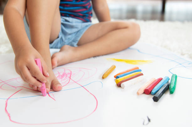 istock Little girl coloring with her hands 1171343182