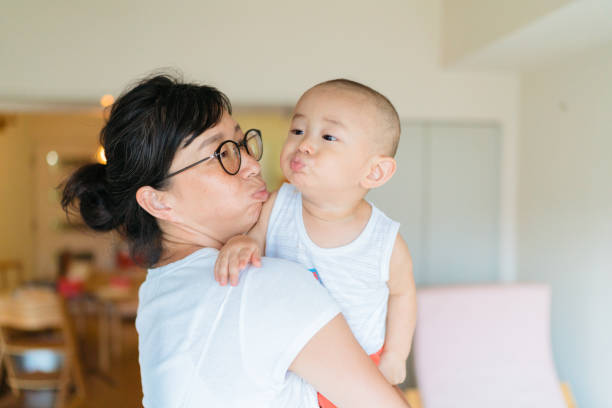 Mother and baby boy making funny face