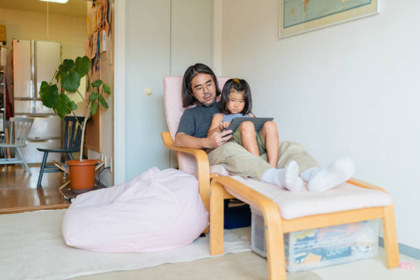 istock Modern father taking care of his daughters at home 1171345634