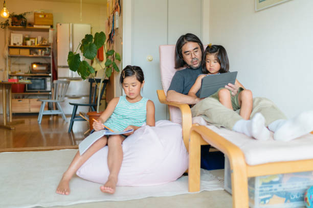 istock Modern father taking care of his daughters at home 1171345665