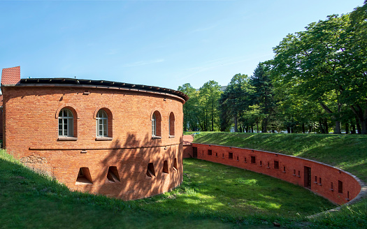 Fort Legionow made with red brick, a component of the Warsaw citadel in summer day with blue sky, Poland