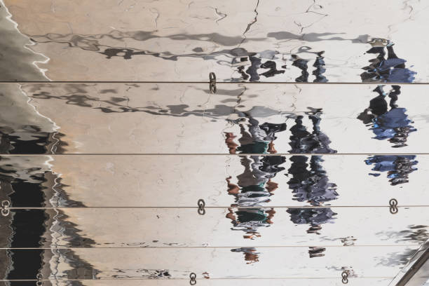 istock Distorted reflection and shadow of pedestrians on the ceiling of a canopy 1171346138