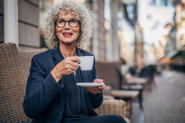 istock Beautiful senior woman drinking a hot drink 1171348601