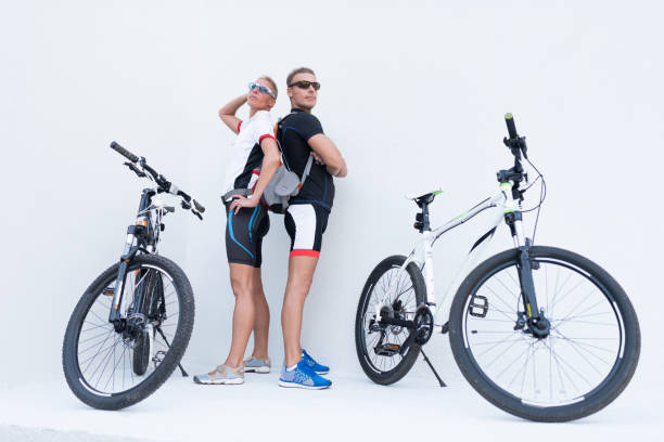 istock Man and woman with bicycles posing on a light background. 1171349245